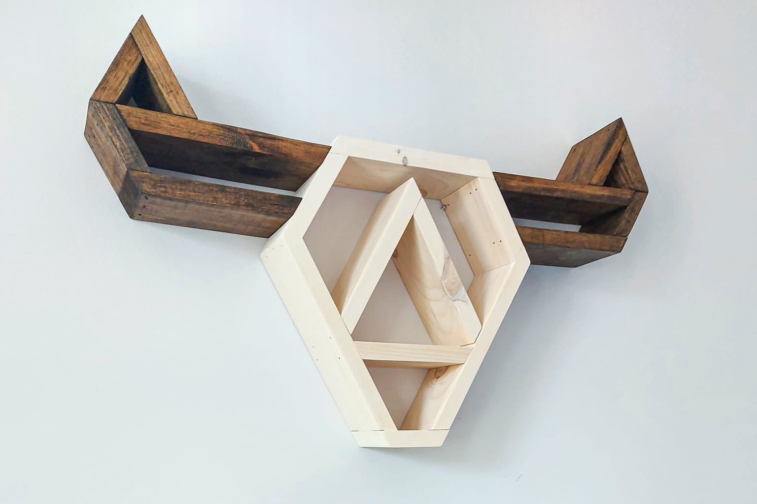 Wooden wall shelf with geometric design on a white background